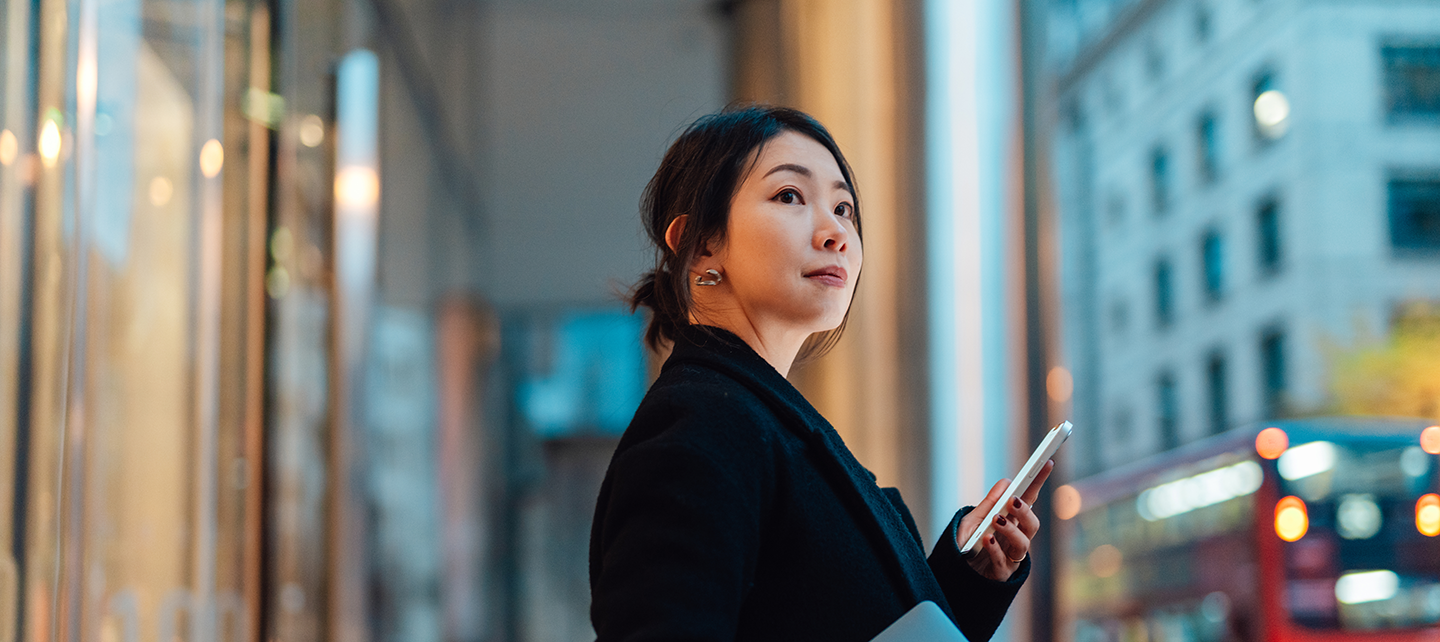 Woman on her phone outside a financial institution