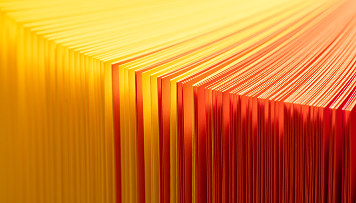 Man using his phone wearing a red bag