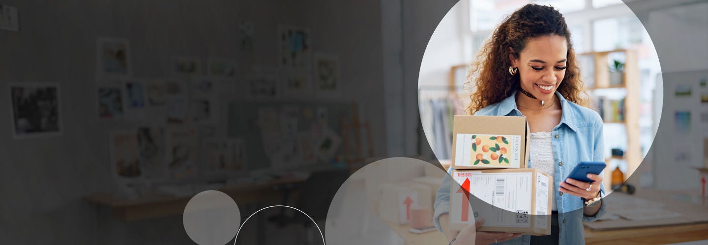 Woman with packages looking at her phoen