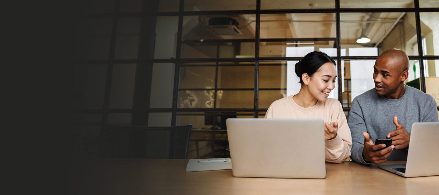 Young coworkers working on laptops in an office.