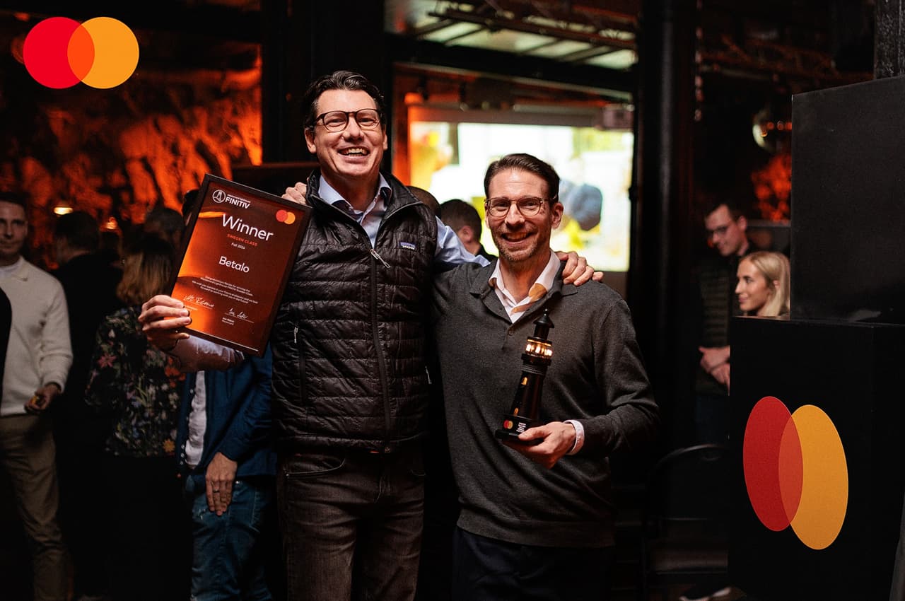 betalo winner holding certificate trophy