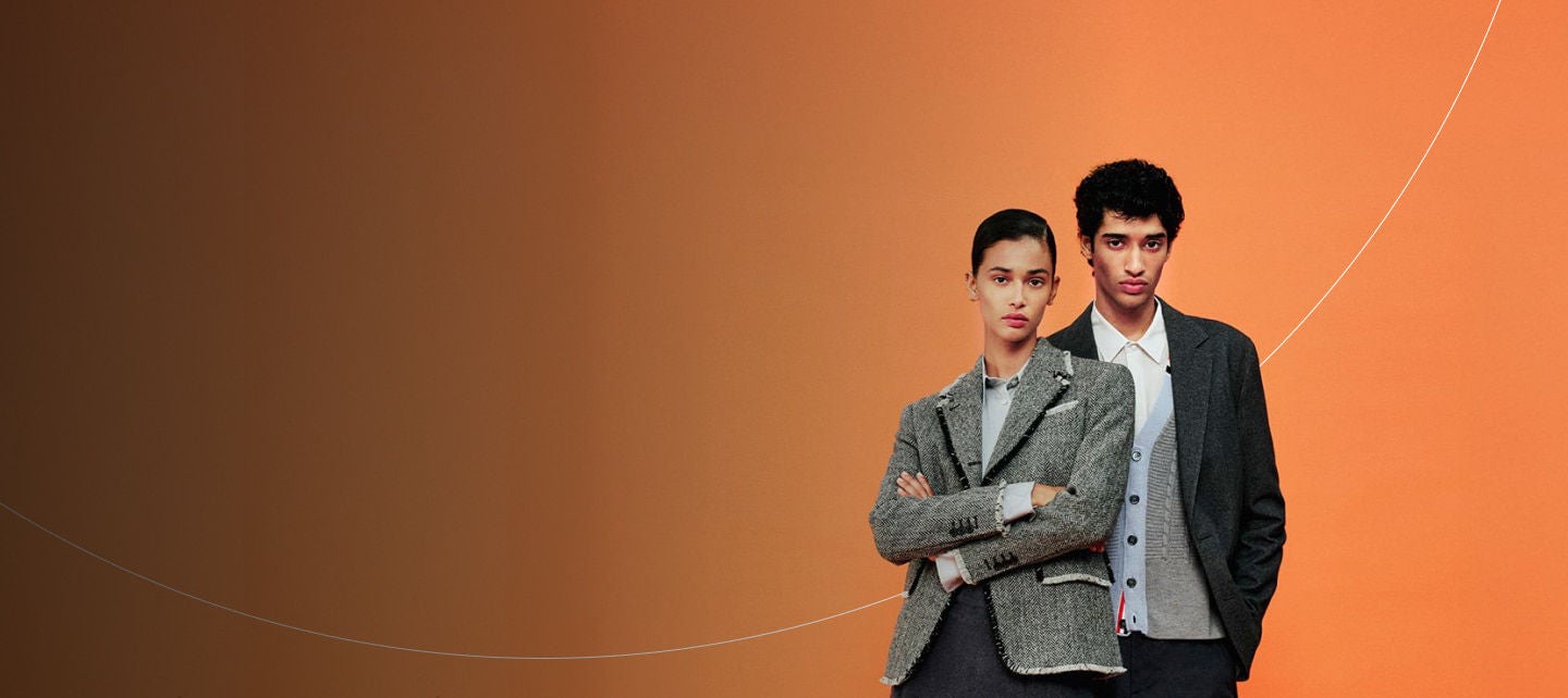 stylish models against bright orange backdrop