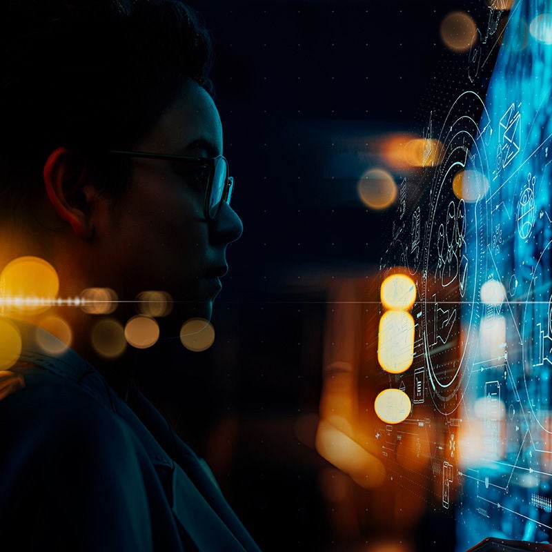 Person looking at data across a dark background
