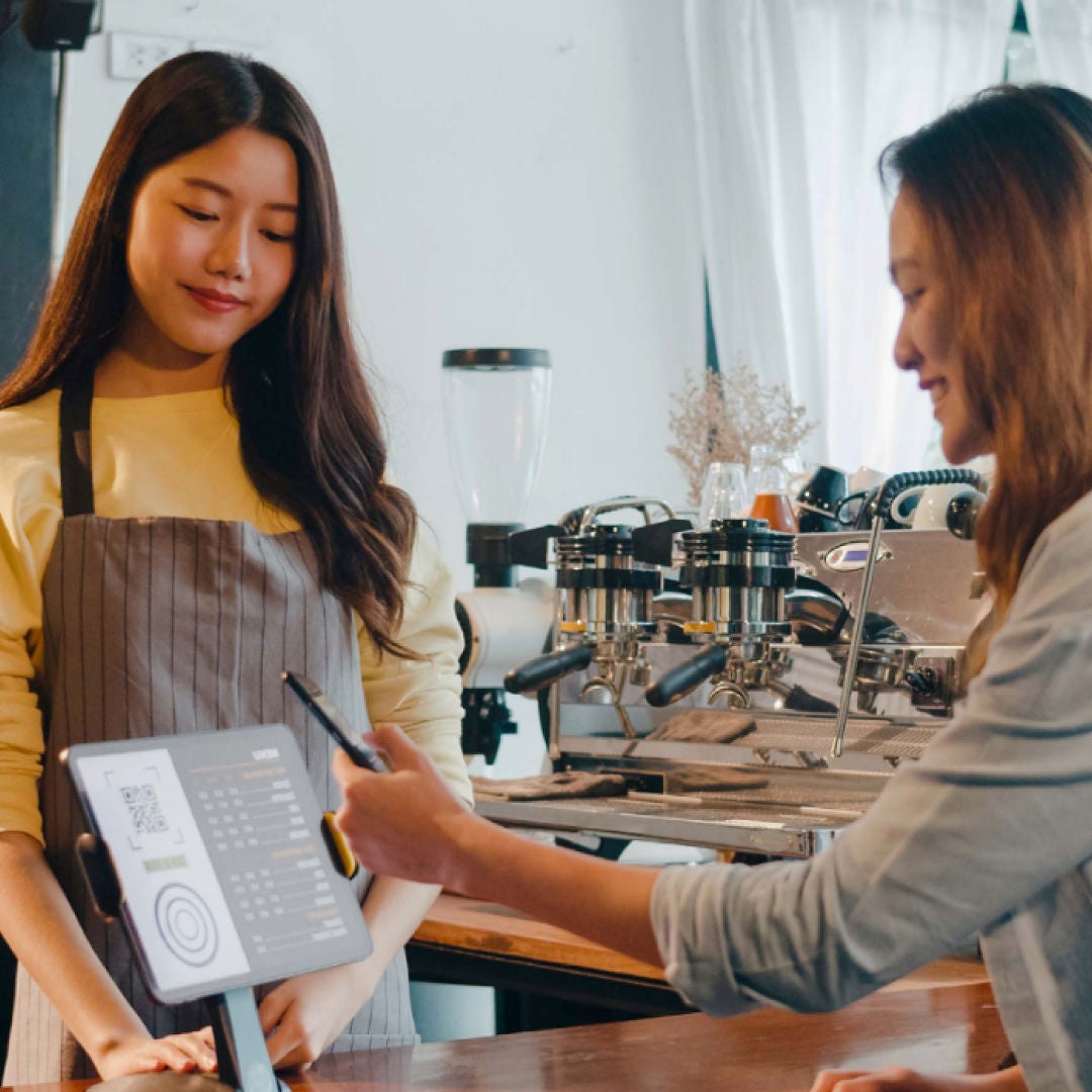 woman smiling while shopping and looking at her phone