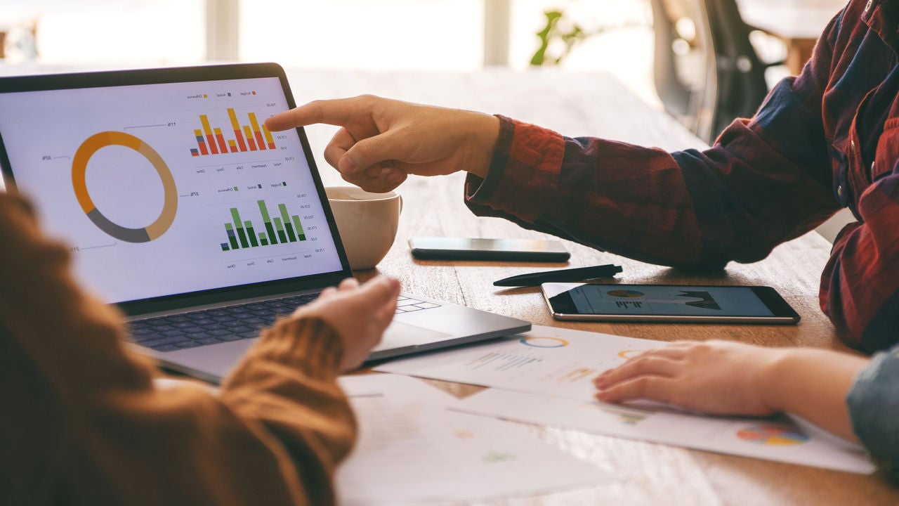 People looking at charts in a computer