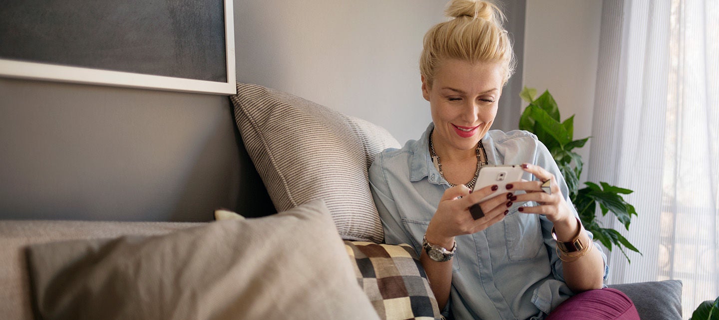 Woman on a couch with her phone
