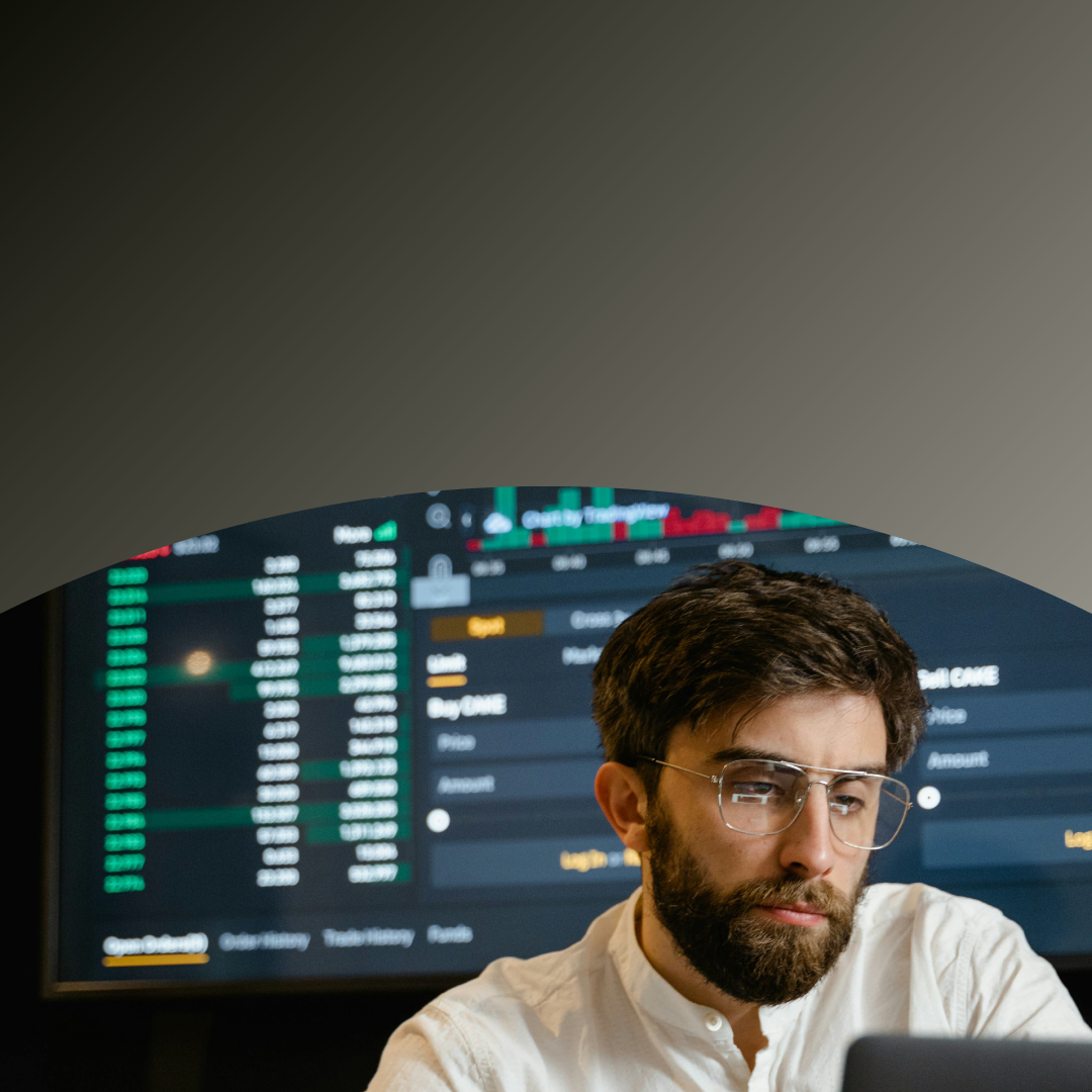 A man looks intently at a laptop screen highlighting blockchain market movements.