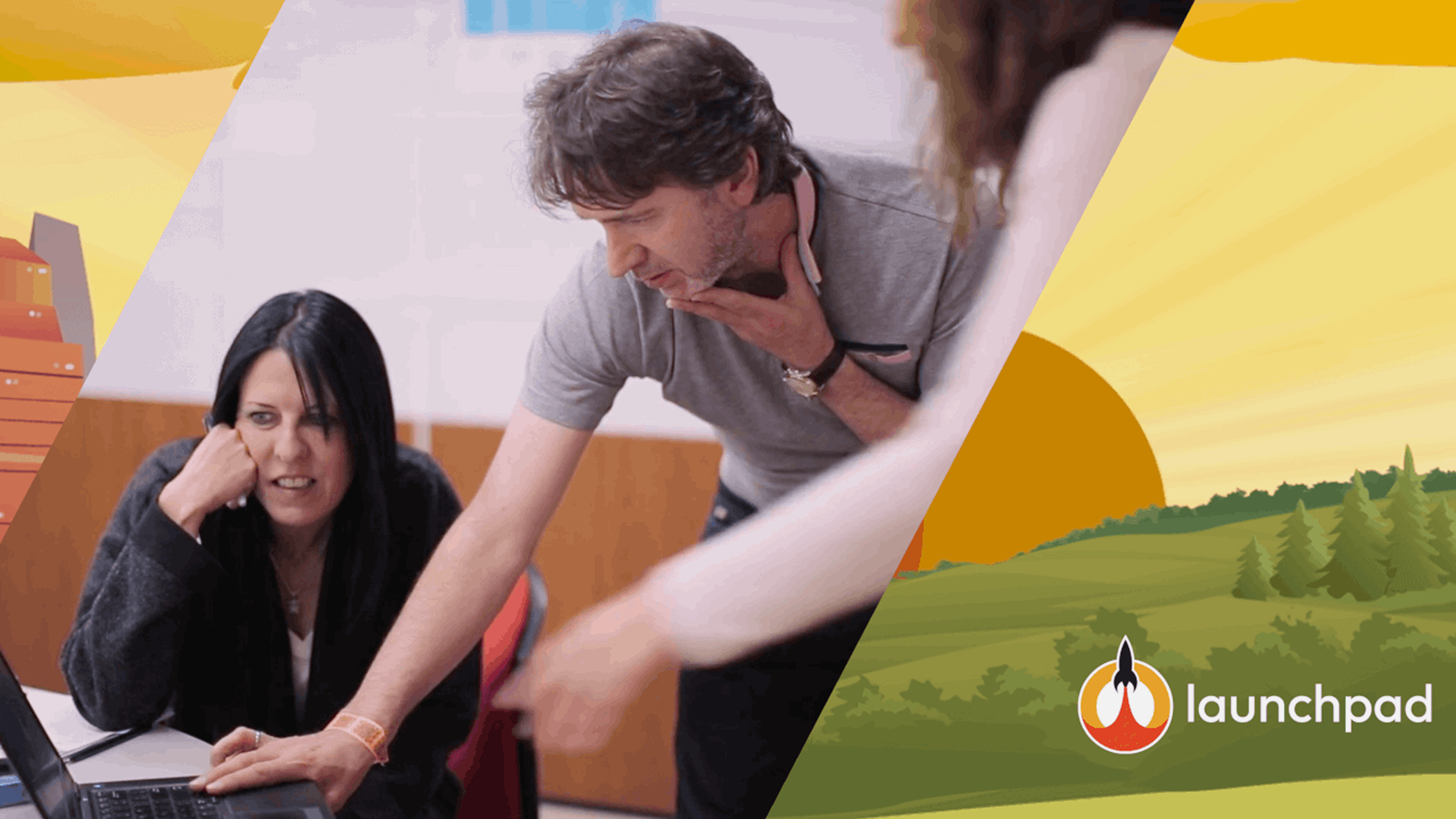 A man and woman looking at a laptop