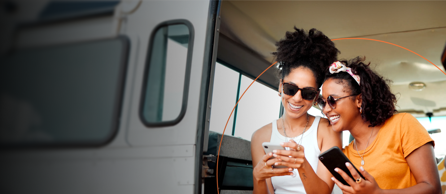 Two women in a van looking at their phone