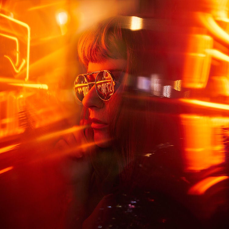 Woman wearing sunglasses at night
