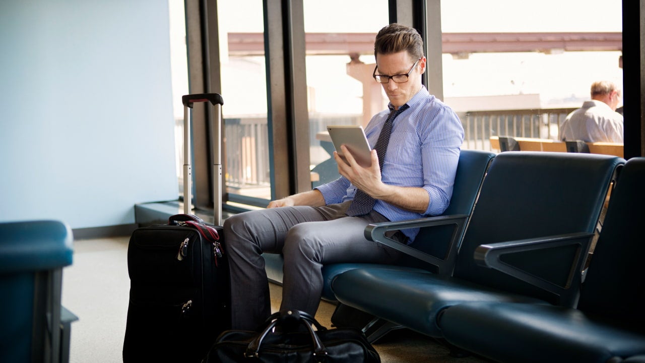 man in airport reading
