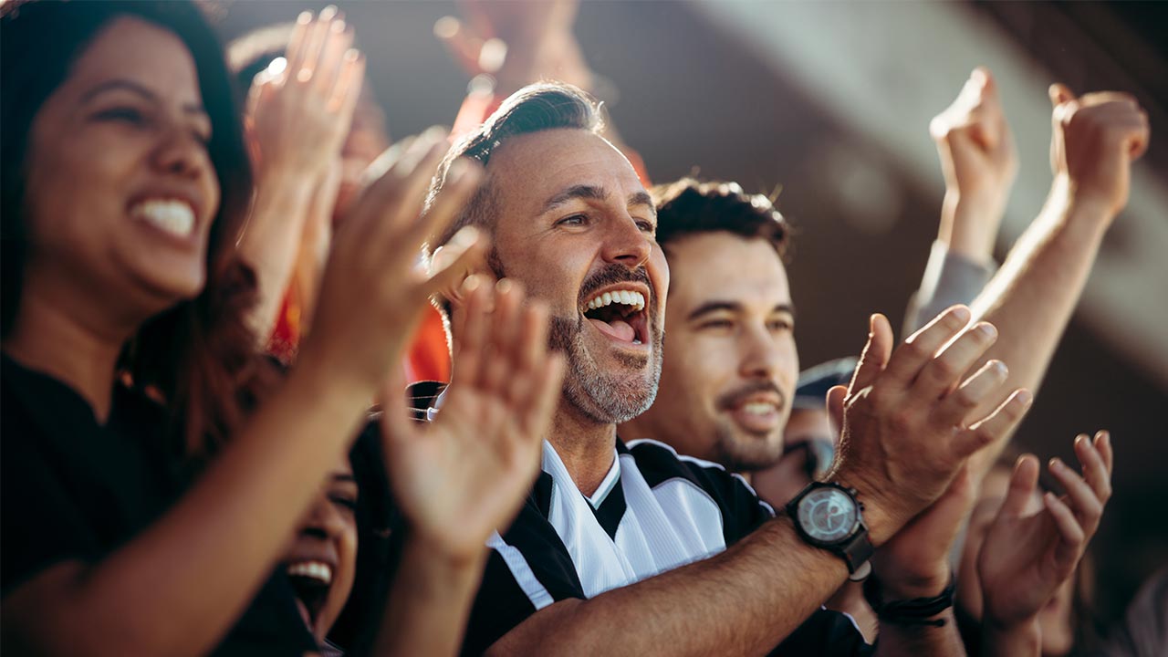 Group of fans cheering their team.
