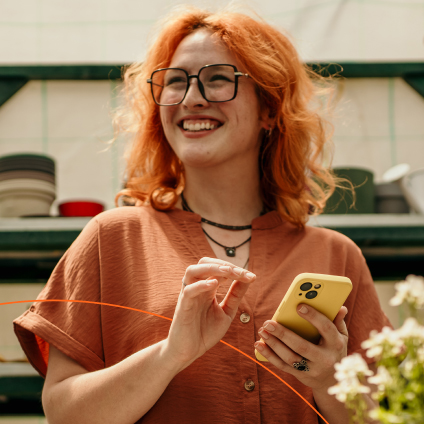 Woman smililng holding phone