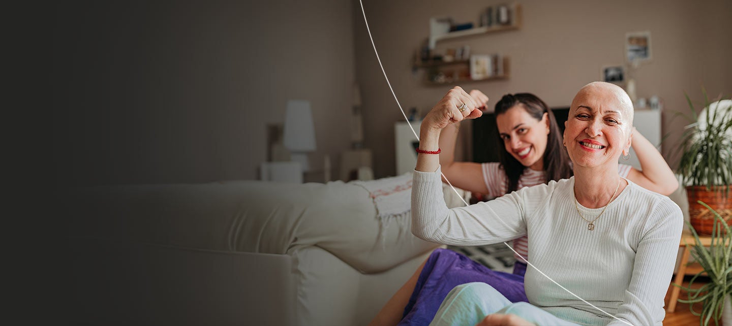Cancer survivor with a daughter, flexing arm in sign of strength.