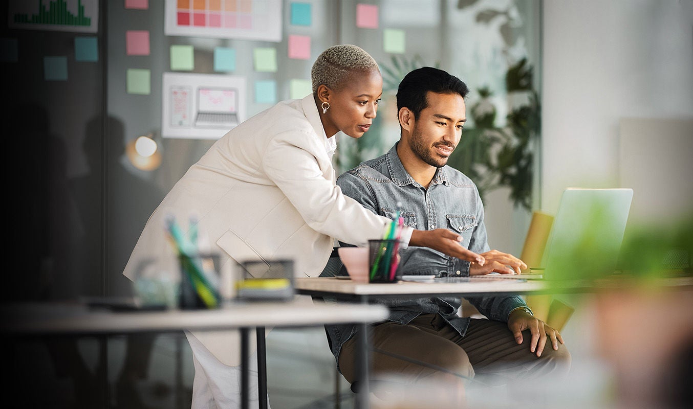 People at a table analyzing computer