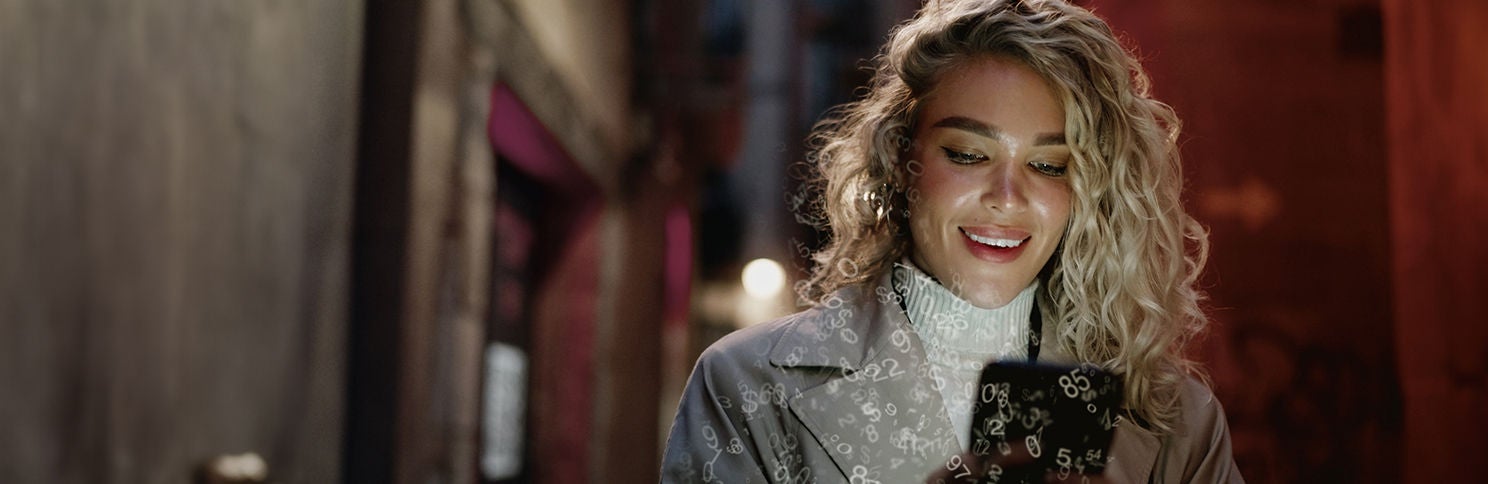 Woman looking at phone smiling