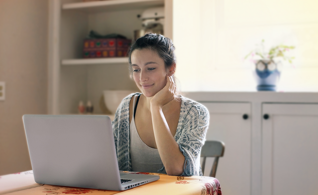 Woman sitting working on laptop.