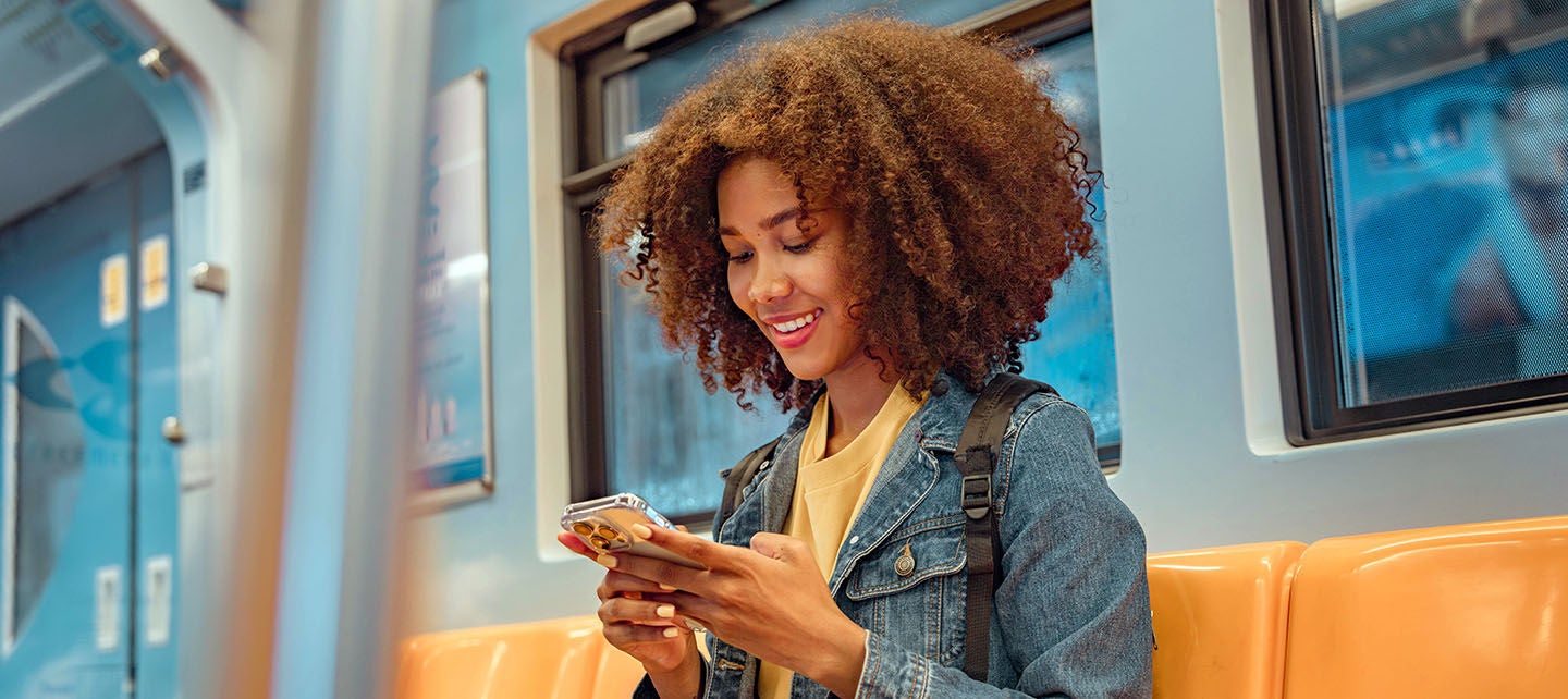 Woman using her phone on the train