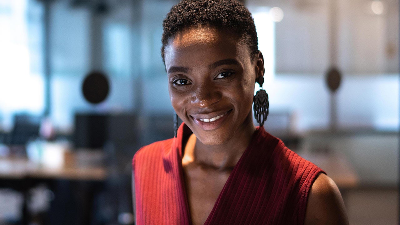 Woman with tablet in a dark office.