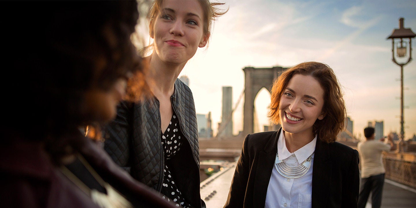Group of young women hanging out on the Brooklyn Bridge, New York