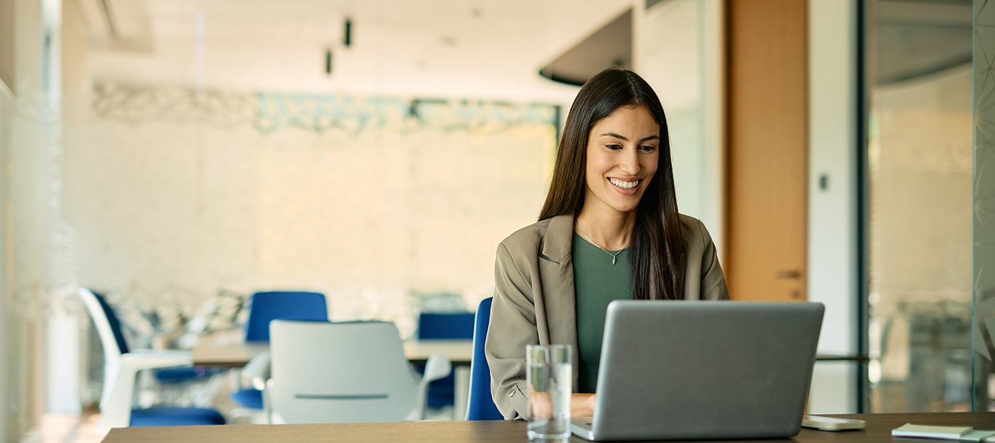 Woman looking at laptop smiling