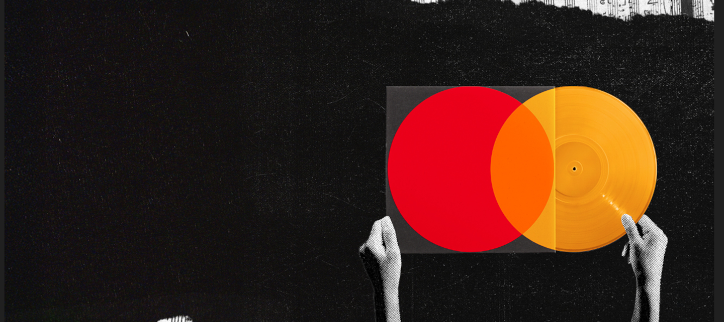 A person holding a yellow record and red sleeve