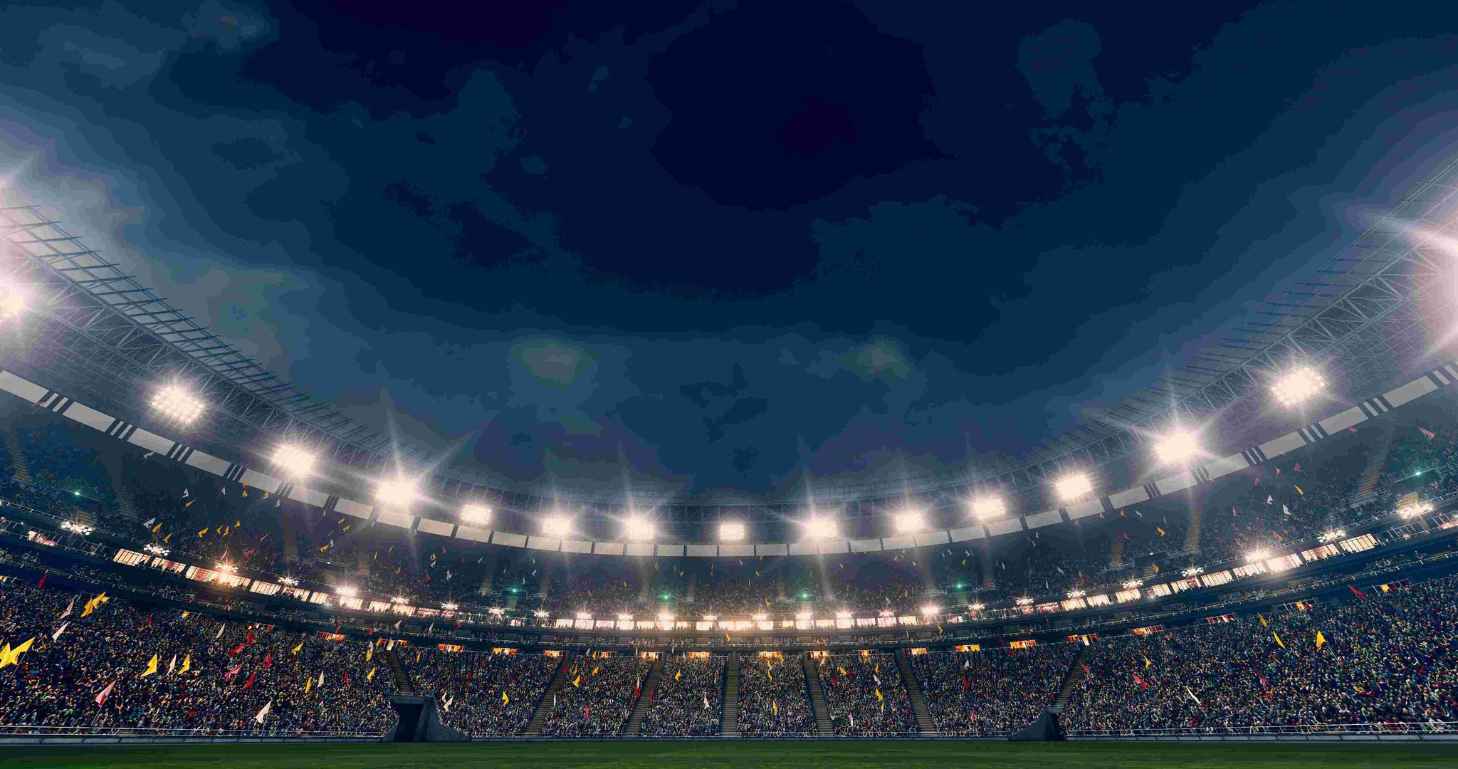 A stadium full of fans at night. 