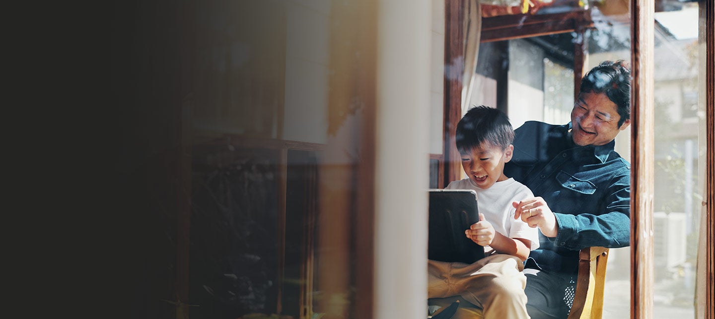 Father and son using a tablet.