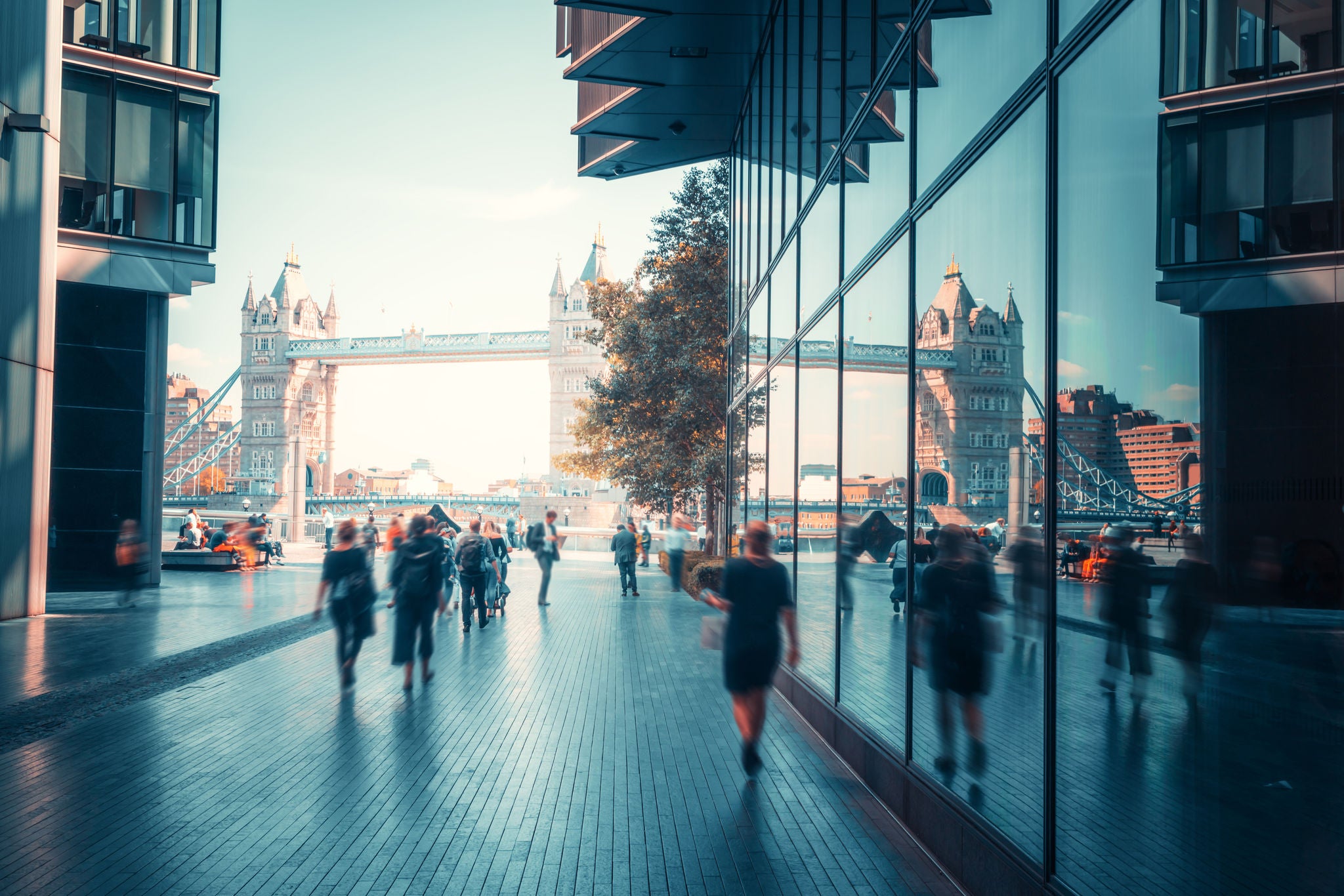 business people, modern buildings and Tower Bridge, London, UK