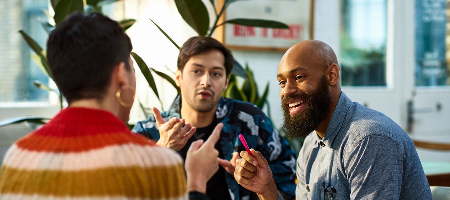 Three people in a lively discussion.