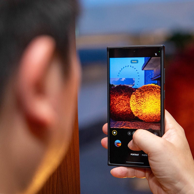 Man holding a phone and taking pictures at RiskX