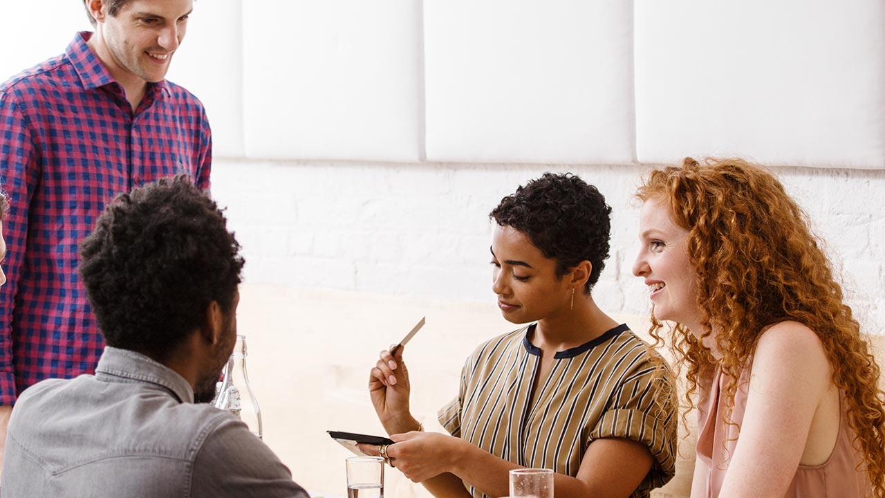 Woman smiling while looking at her phone.