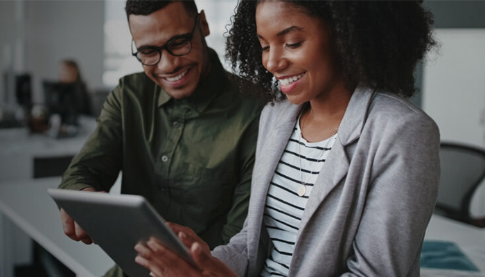 Man and woman looking at a tablet