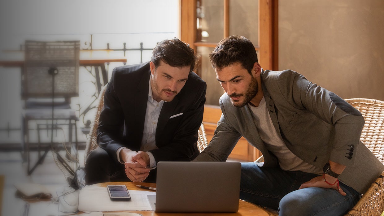 man helping quickly oboard customer using laptop.