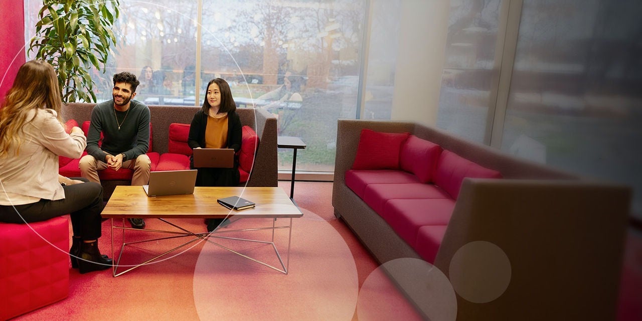 Exployees having a meeting in glass room desktop banner.