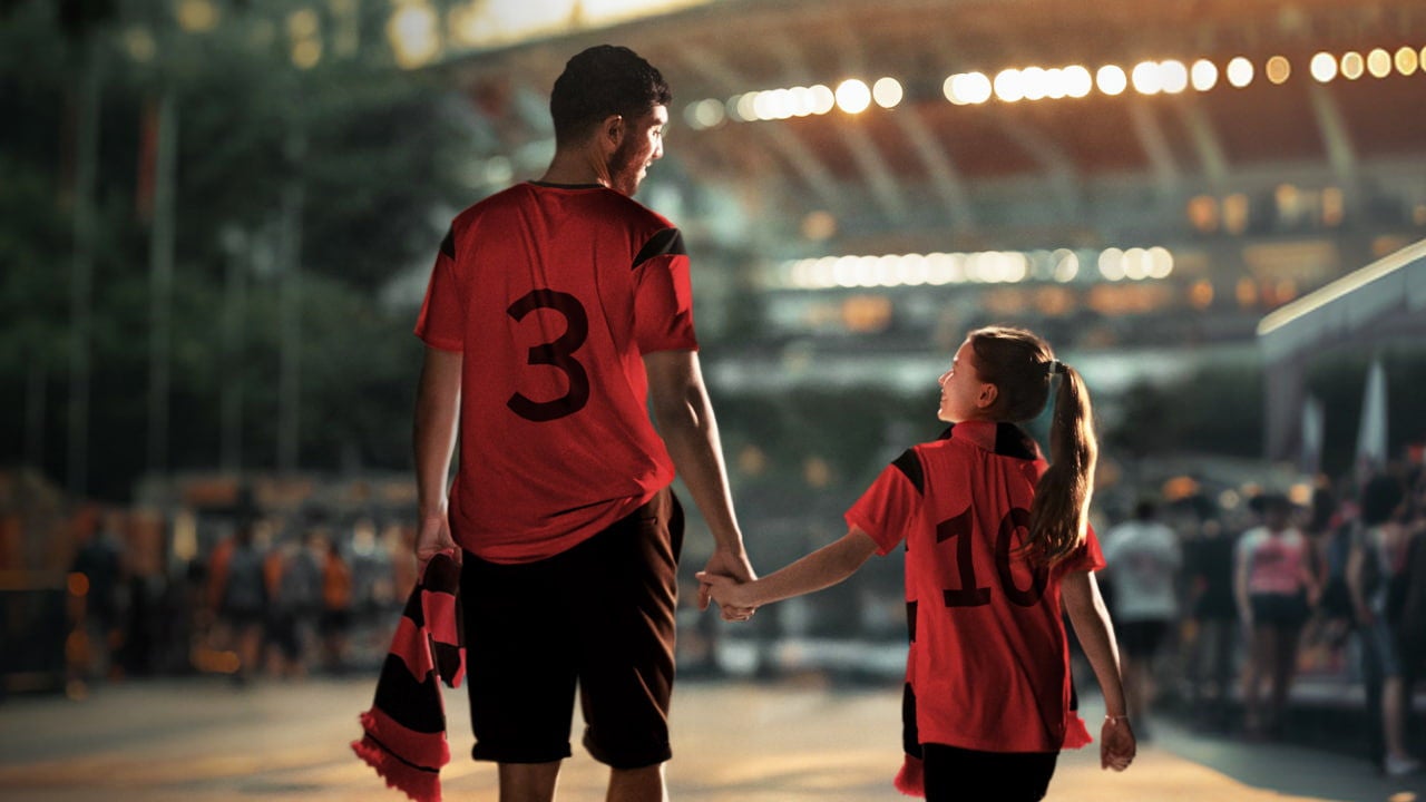 fan walking with football player