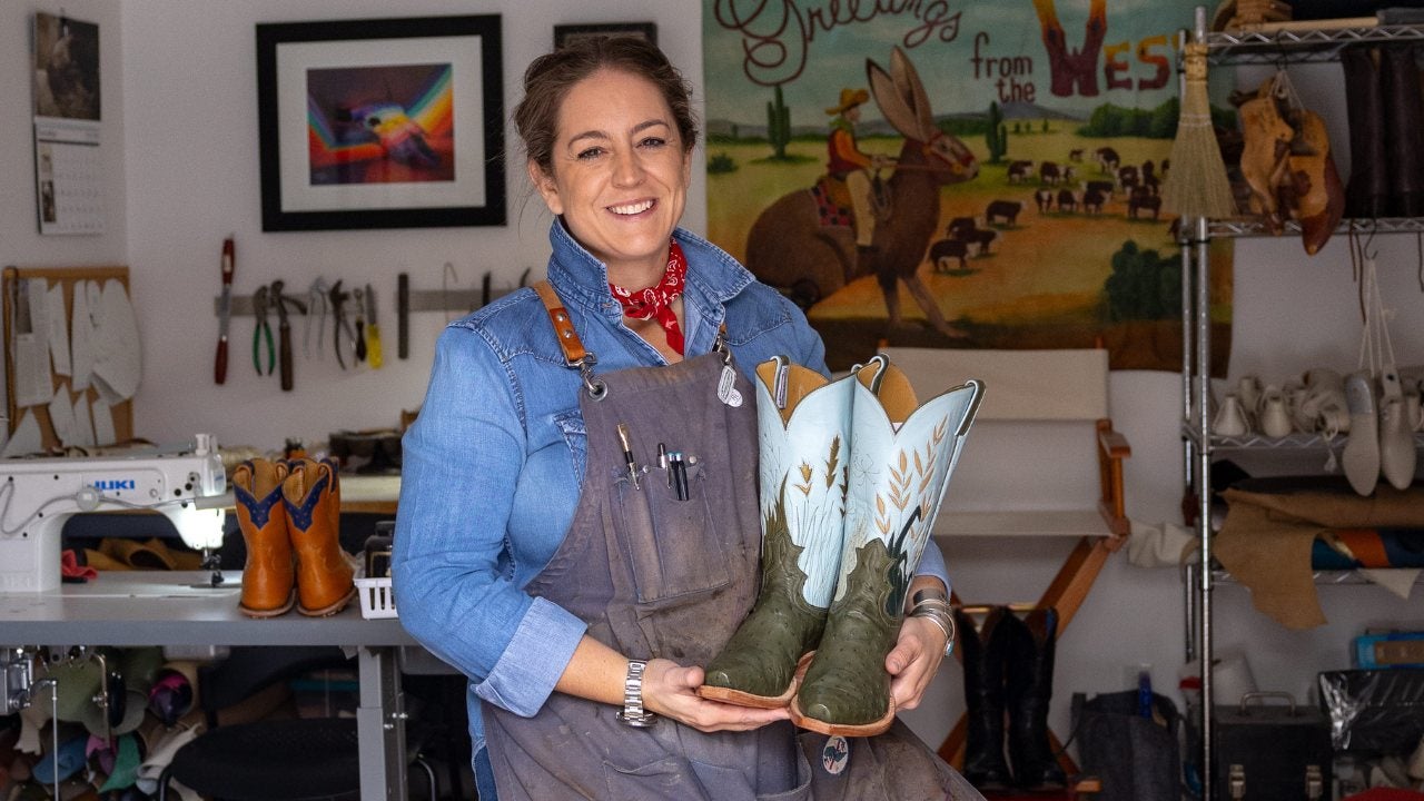 Morgan Buckert holds a pair of her custom cowboy boots in her studio.