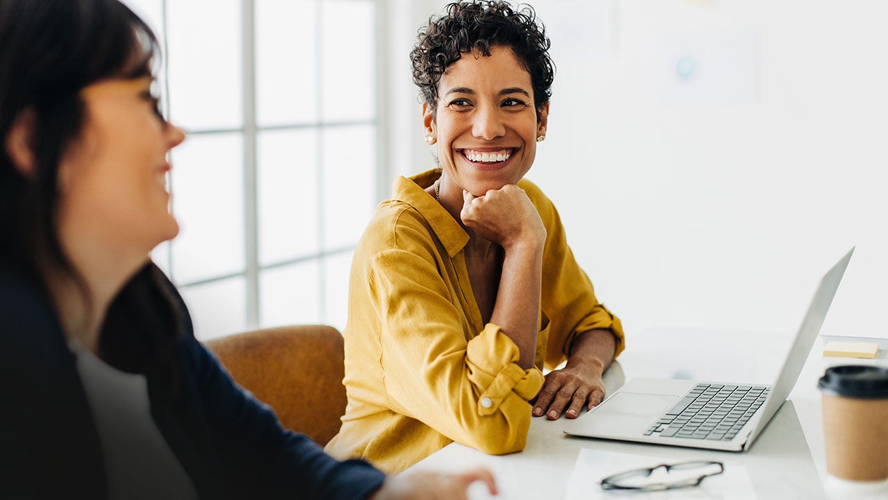 Business woman talking to her colleague in a meeting.
