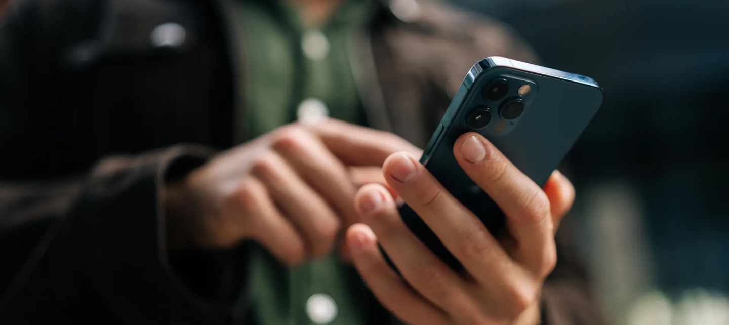 A man a looking into his mobile