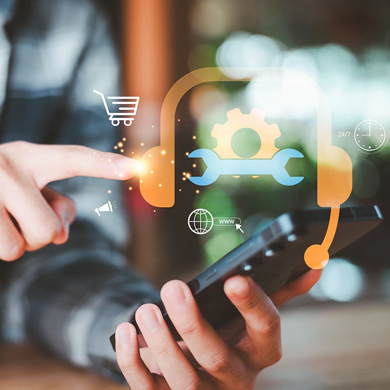 Person with mobile phone and gear icon overlay