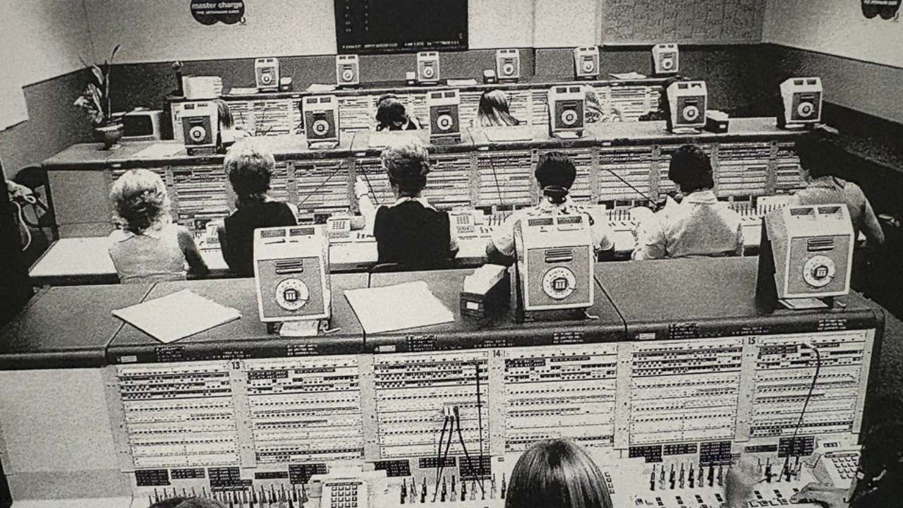 Rows of women in front of authorization equipment. 