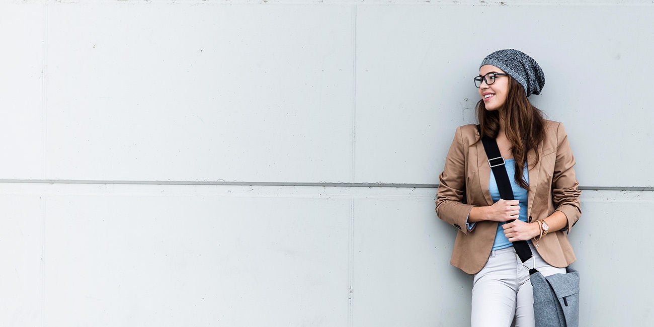 Two smiling people enjoying the benefits of being a Mastercard cardholder.