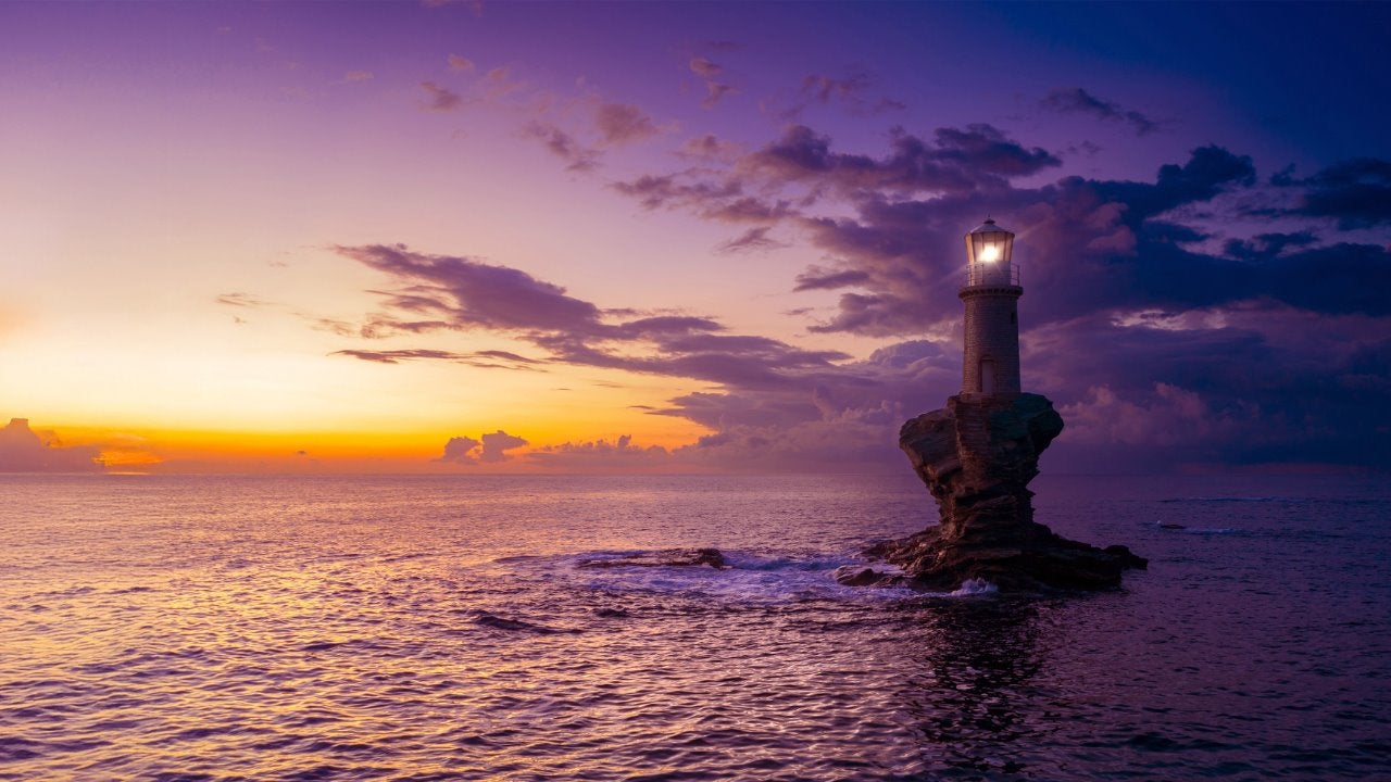 A buoy floats in a body of water at sunset. 