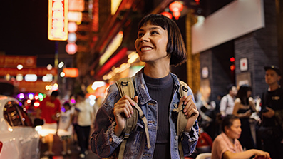 Happy woman looking off into distance in a city setting