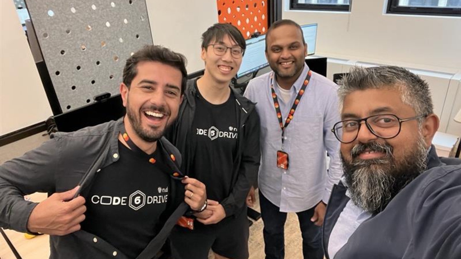 Four men taking a selfie picture.