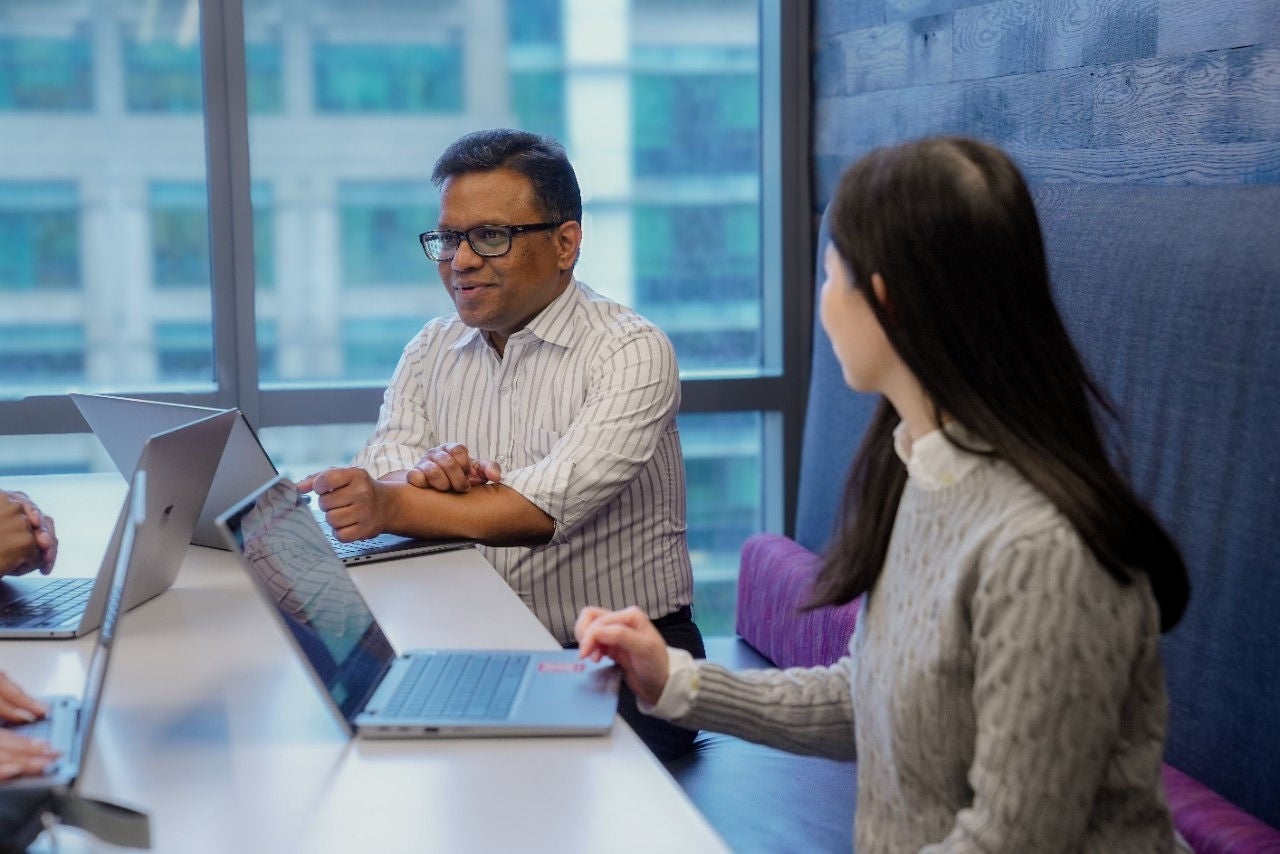 Coworkers conversing in the cafeteria