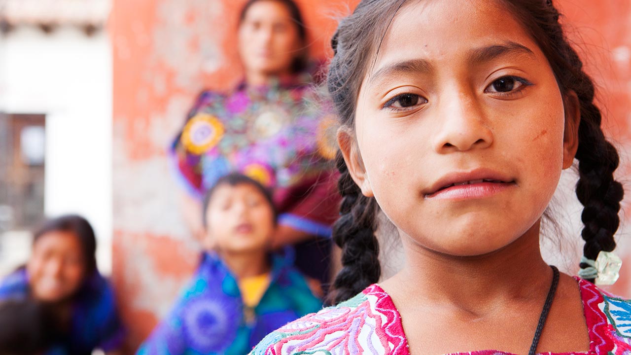 Hispanic girl smiling with family
