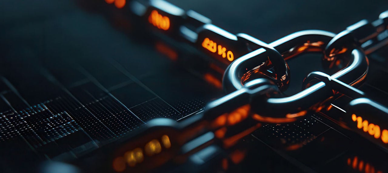 A close-up image of a chain illuminated by orange lights.
