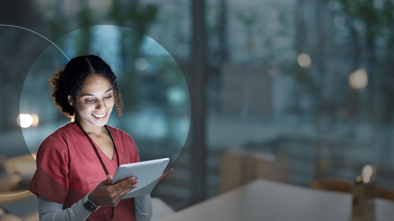 אחות רפואית במדי אחות משתמשת בטאבלט.