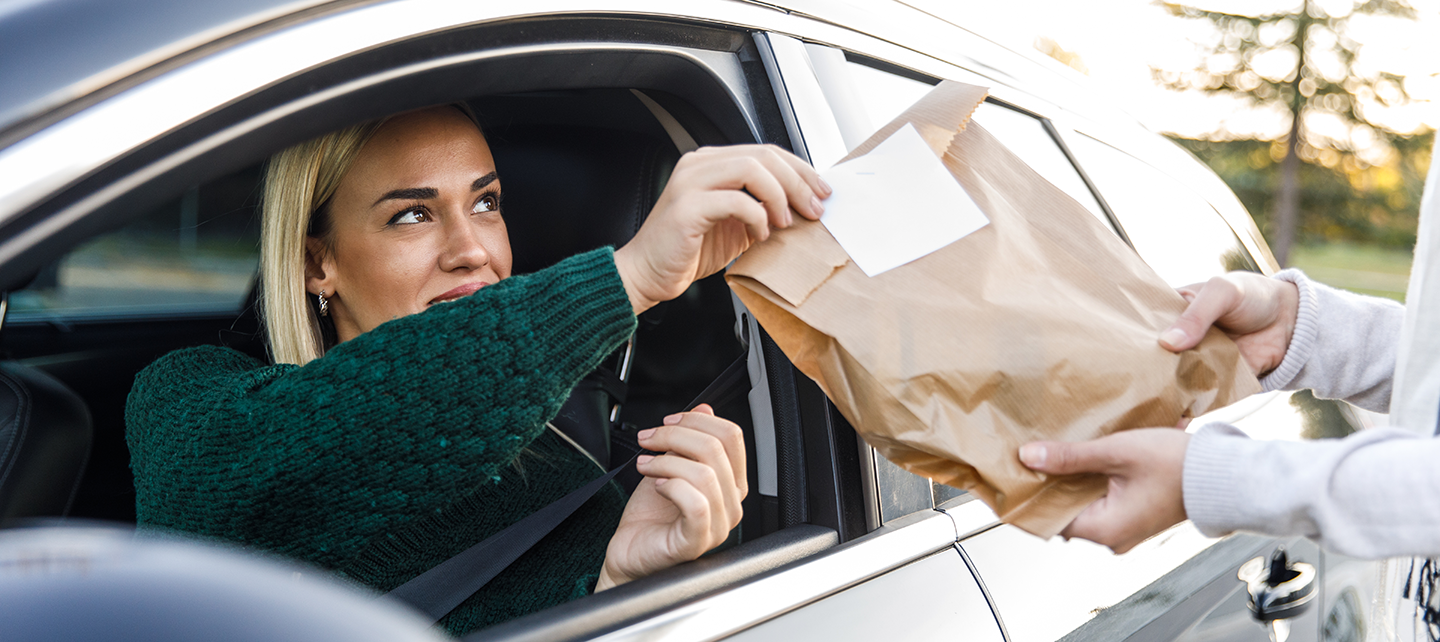 Woman getting her drive-thru order